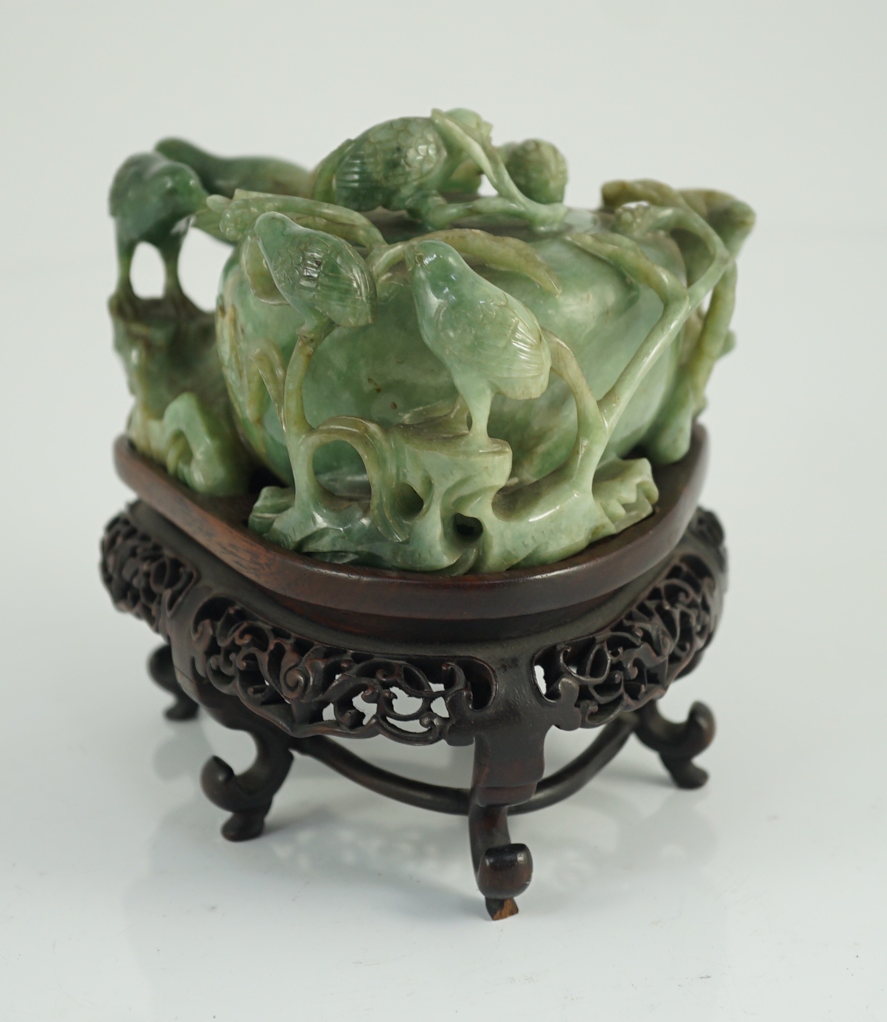 A Chinese jadeite ‘quail and millet’ water pot and stand, late 19th century, original carved and pierced wood stand, total width 15.2cm